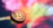Bitcoin is a new concept of virtual money on a colorful background, a coin with the image of the letter B, close-up. Conceptual image of a digital cryptocurrency and payment system.